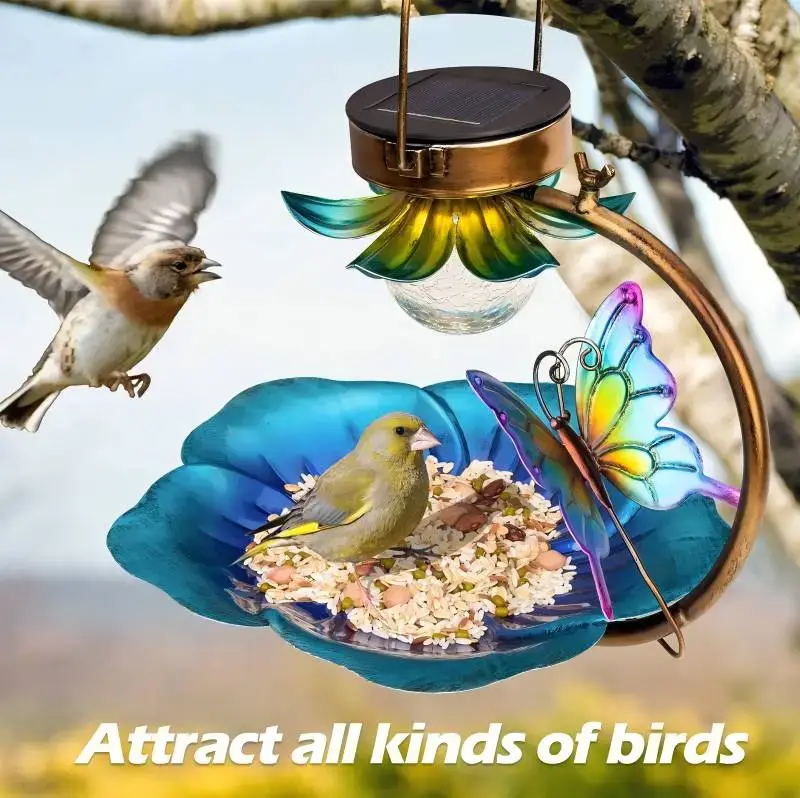 Solar-powered bird feeder with butterfly design in a garden