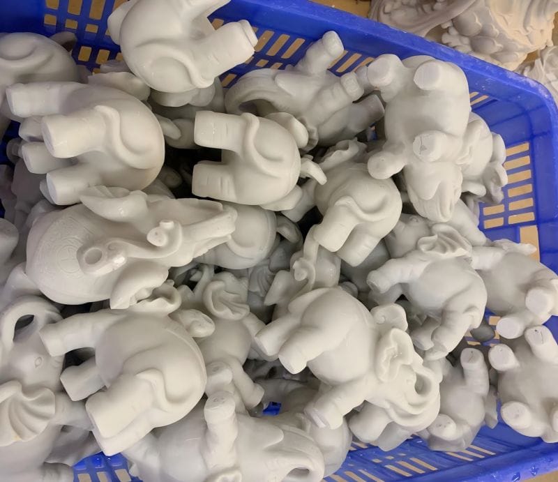 Unfinished Resin elephant figurines in a basket