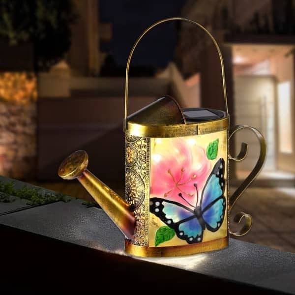 Solar watering-can lantern with painted butterfly and flower panel, hanging or tabletop