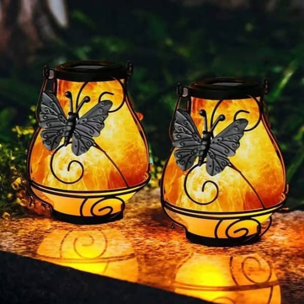 Pair of glass globe solar lanterns with metal butterfly overlays (tabletop/ground)