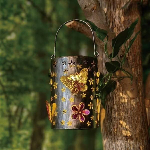 Hanging metal lantern with butterfly and flower cutouts, solar-powered