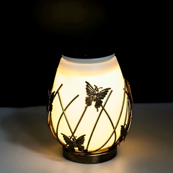 Tabletop frosted-glass solar lamp with decorative metal butterfly cage