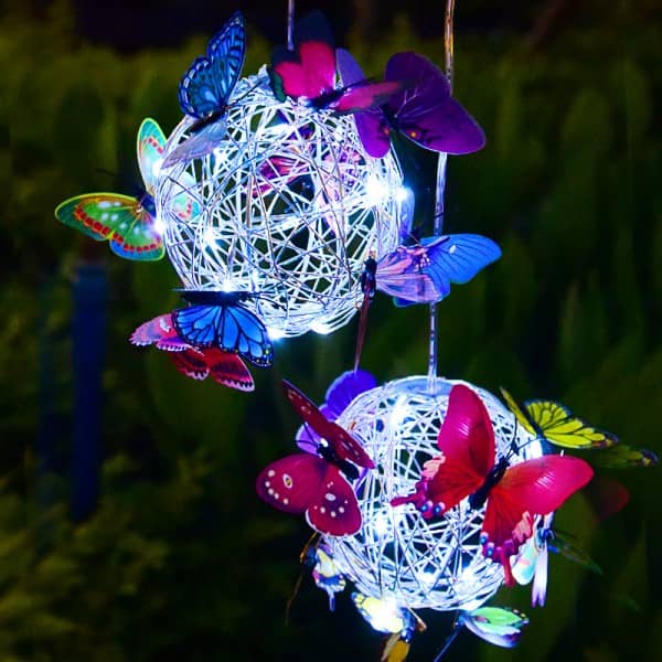 Hanging woven globe string lights with colorful butterfly accents, solar-powered
