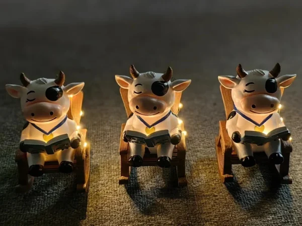 SM24591 Solar Resin Statue - Cow Sitting on Chair Freestanding Animal Light