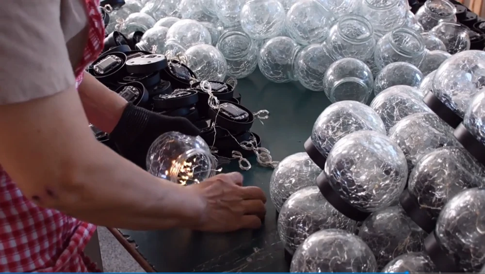 glowyard's worker is doing integration of housings, solar panels, led modules, battery packs and control boards