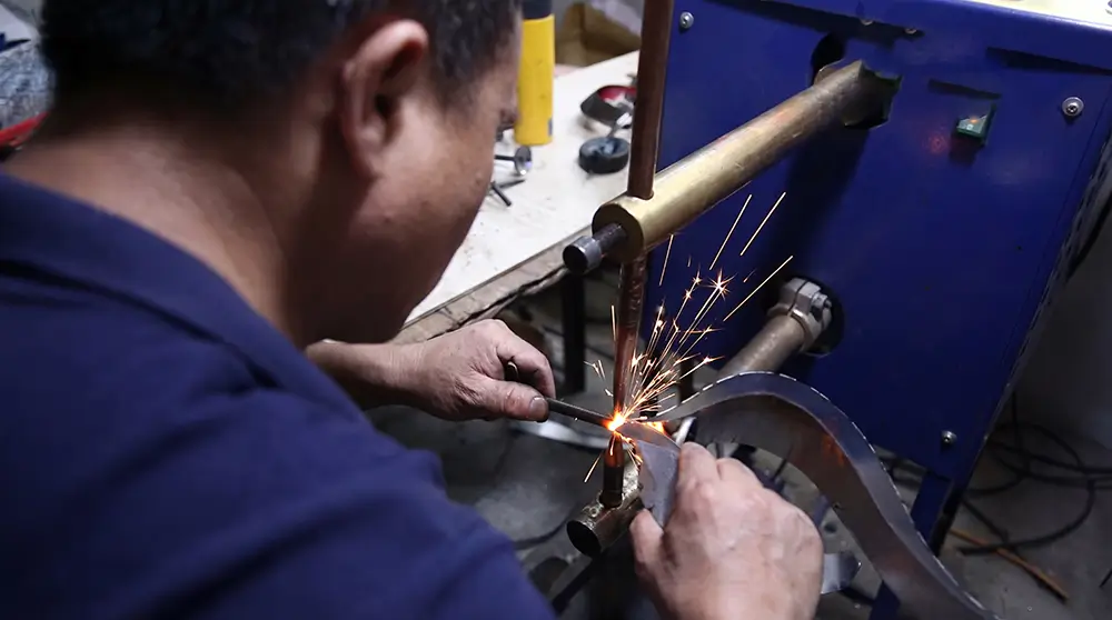 glowyard's worker is doing surface finishing work for solar stake light